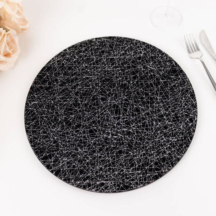Black round plate with intricate white geometric patterns