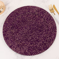 Purple round plate with gold abstract design on a marble surface.