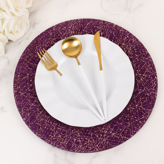 Elegant white and gold cutlery set on a purple decorative plate.
