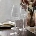 Set of three elegant clear glass stemware on a dining table.
