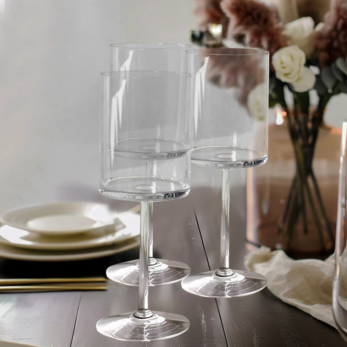 Set of three elegant clear glass stemware on a dining table.