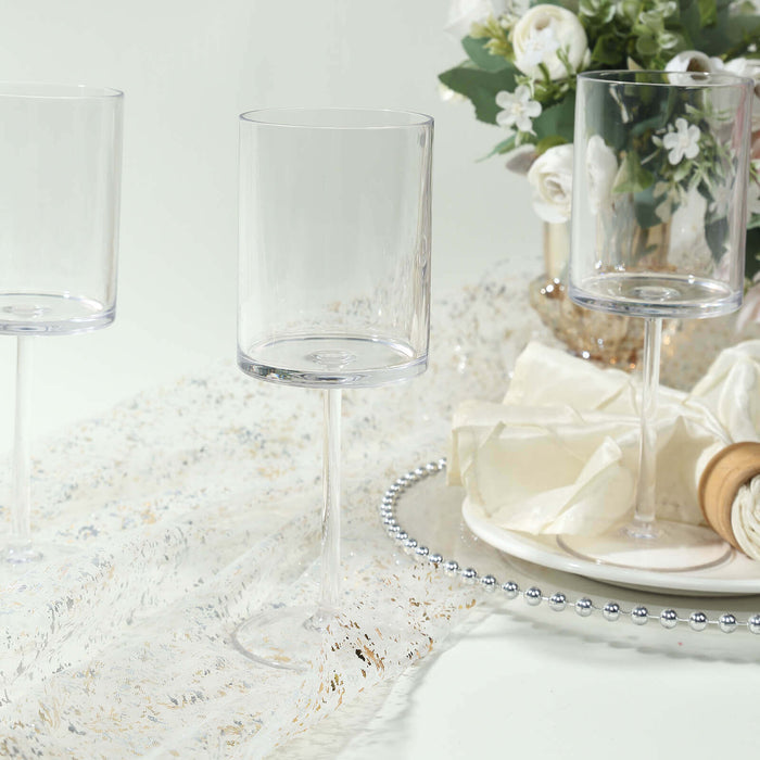 Elegant clear acrylic stemmed glasses on a festive table setting.