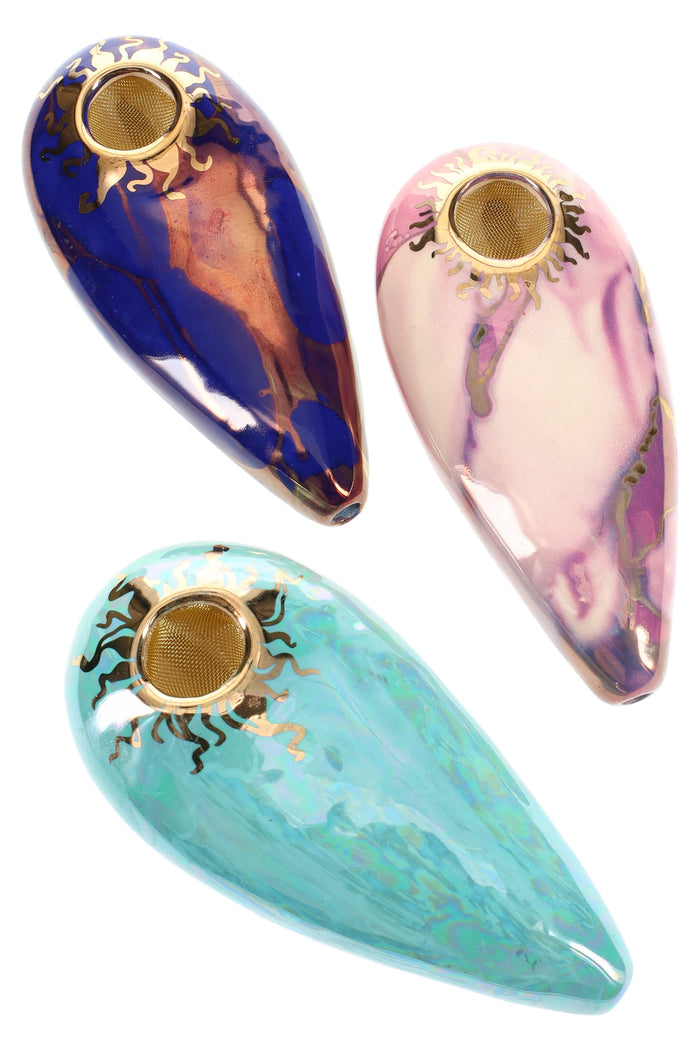 Trio of 4-inch oval ceramic hand pipes with brass screen bowls and gold sun rims in blue, pink, and teal glazes.