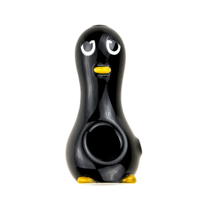 Penguin-shaped glass hand pipe with black body, white belly, yellow beak, and yellow feet