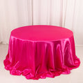 Round pink satin tablecloth with elegant draping.