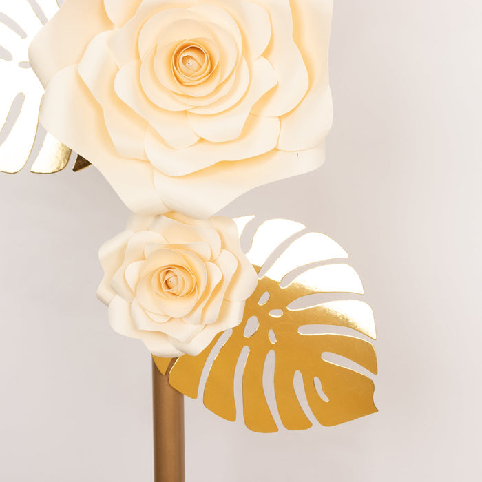 Cream paper flowers with gold accents on a modern floral decor piece.