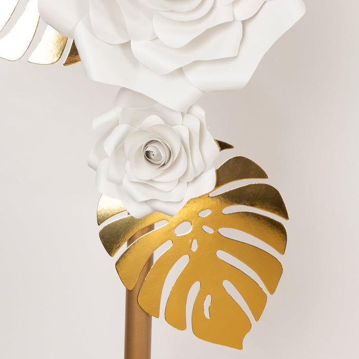 White and gold decorative flower and leaf wall art.